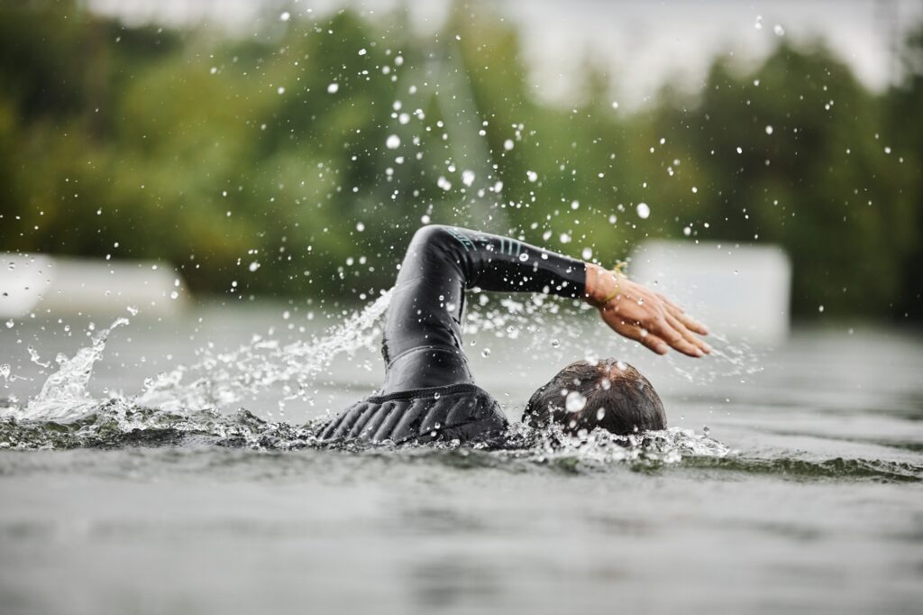 Man Swimming in Lake with Water Splashes