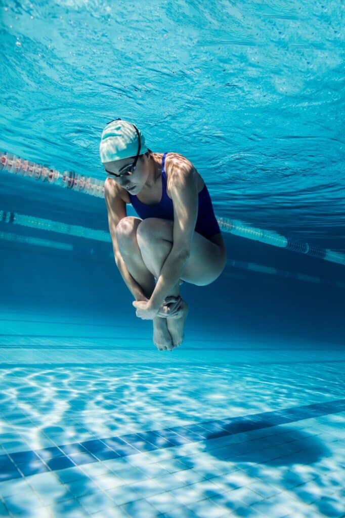 underwater picture of young female swimmer exercising in swimming pool